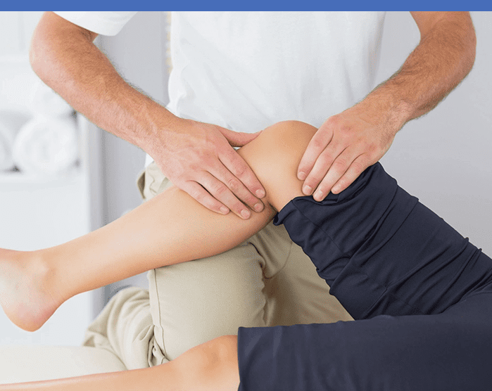 A person is getting their leg examined by an osteopath.