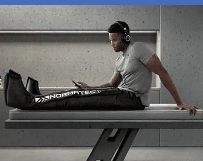 A man sitting on top of a bench with headphones.